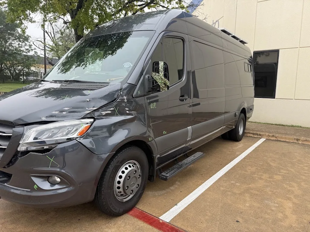 Grey Mercedes-Benz Sprinter van with heavy front-left collision damage on arrival — grille missing, headlight and bumper broken, front fender crumpled
