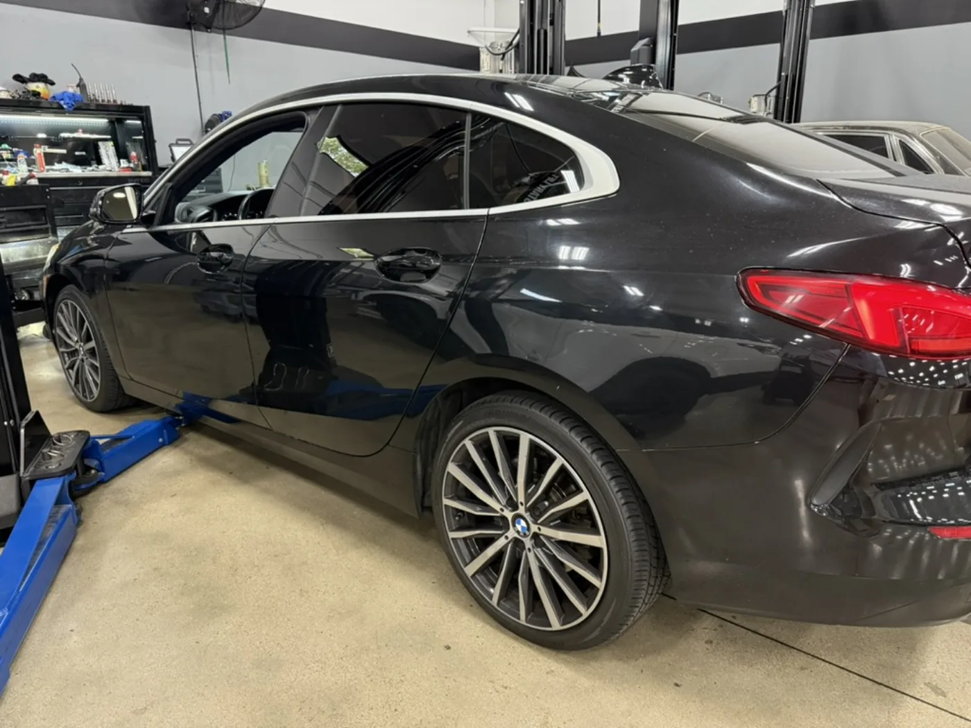 Glossy black BMW coupe after refinishing