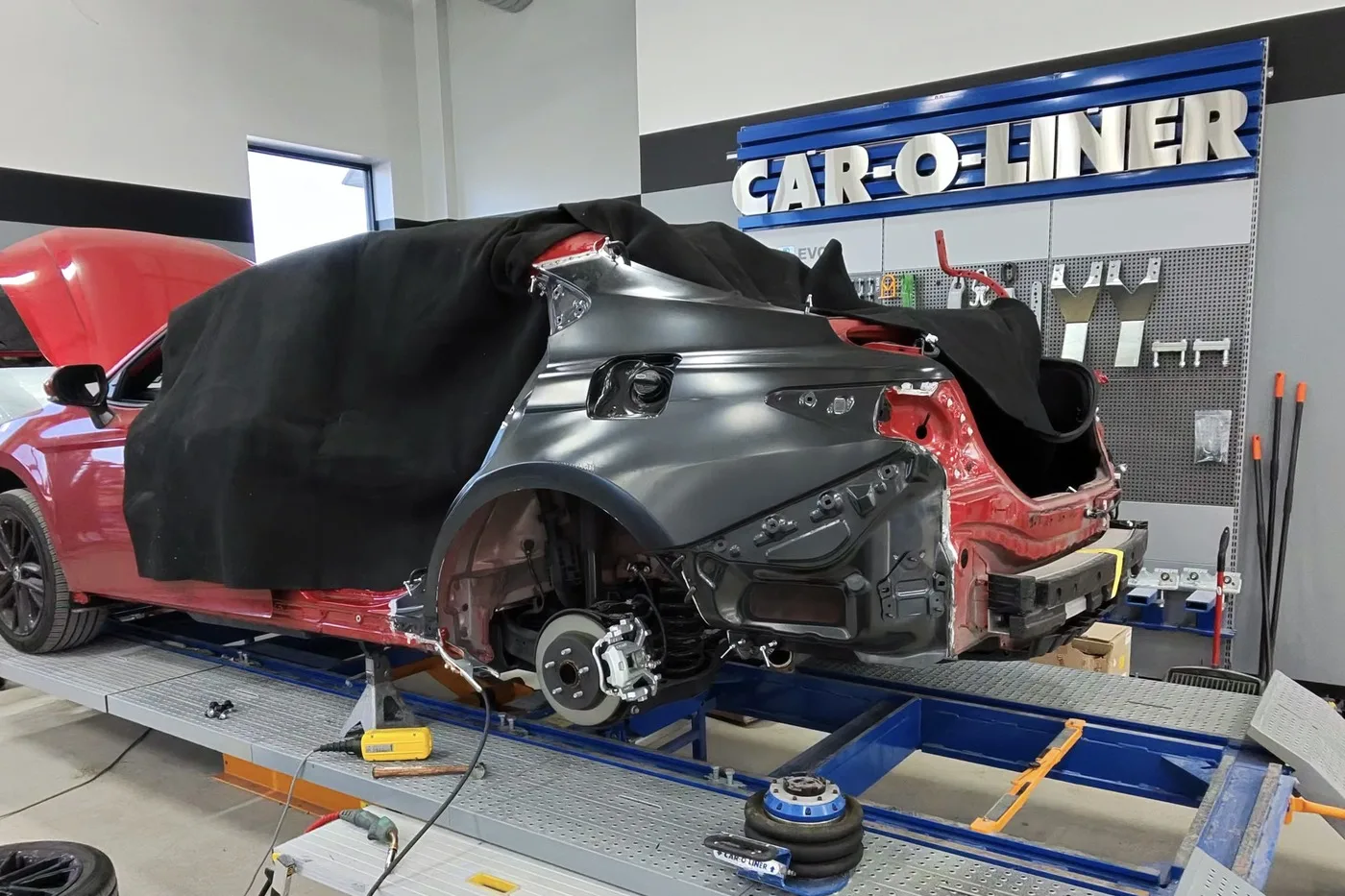 A vehicle mounted on the Car-O-Liner frame bench for structural measurement